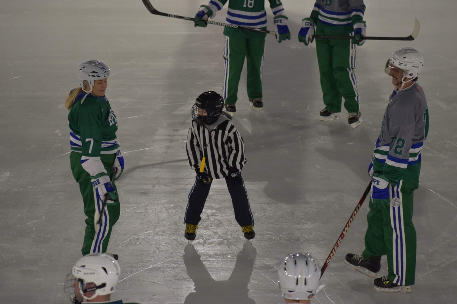 Players from team hope and team cure face off for the first puck drop of the World's Longest Hockey Game.