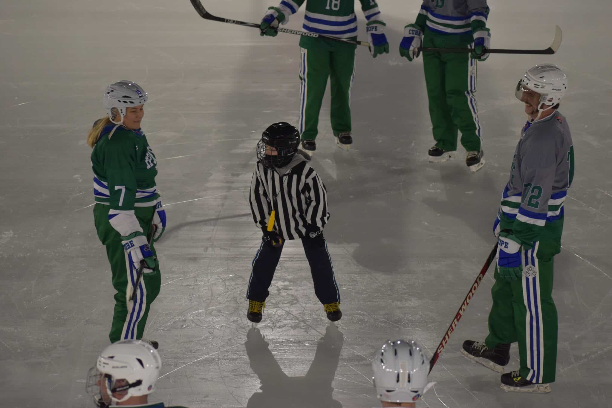 Players from team hope and team cure face off for the first puck drop of the World's Longest Hockey Game.